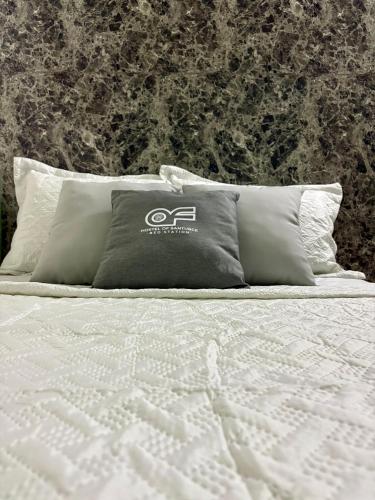 a bed with a pillow on it with a wall at Hostel of Santurce in San Juan