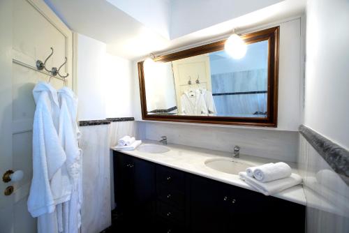 a bathroom with a sink and a mirror at Epidaurus Olive Villa in Nea Epidavros