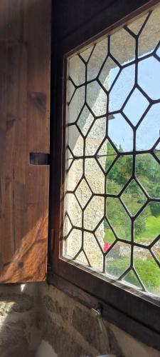 a window in a room with a view of a yard at Manoir de Kerenneur in Plourin