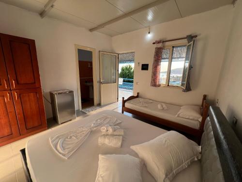 a bedroom with two beds and a tv at Blue Marli Rooms in Himare