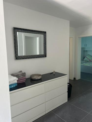 a bathroom with a sink and a mirror on the wall at Apartmani Lana in Rab