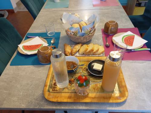 a table with a tray of food and drinks on it at La maison B et JB in Tarbes