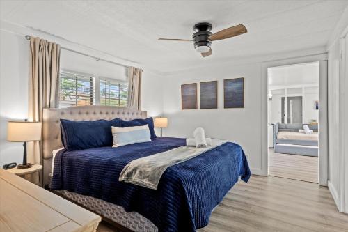 a bedroom with a bed with a blue comforter at Lakefront Mountain Oasis in Dandridge