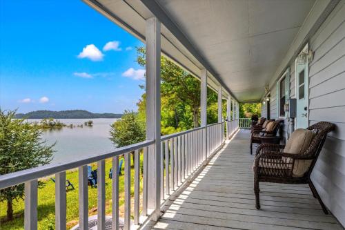 a porch with chairs and a view of the water at Lakefront Mountain Oasis in Dandridge
