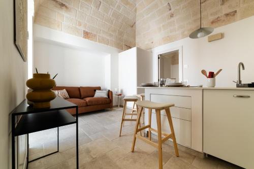 a kitchen and living room with a couch and a table at DIMORA Santa Lucia - LUXURY HOUSE in Monopoli