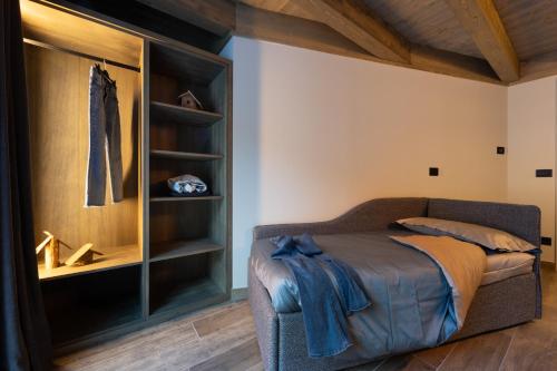 a bedroom with a bed and a book shelf at Lillaz Home - Apartments in Cogne
