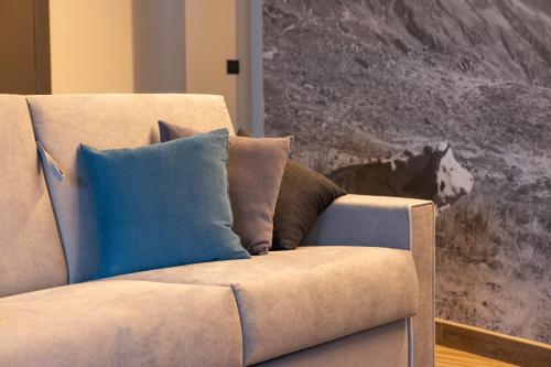 a couch with two pillows on it in a living room at Lillaz Home - Apartments in Cogne