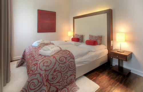 a bedroom with a large bed with a large mirror at Hotel Elbresidenz an der Therme in Bad Schandau