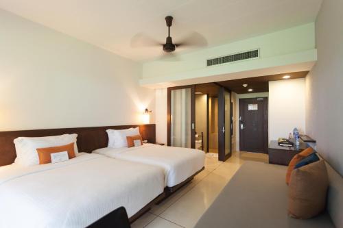 a hotel room with two beds and a bathroom at Southsea Khaolak Beach Resort - Soft Opening in Khao Lak