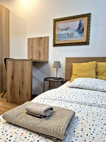 a bedroom with a bed and a picture on the wall at Apartmány v srdci Ružinova in Trnávka