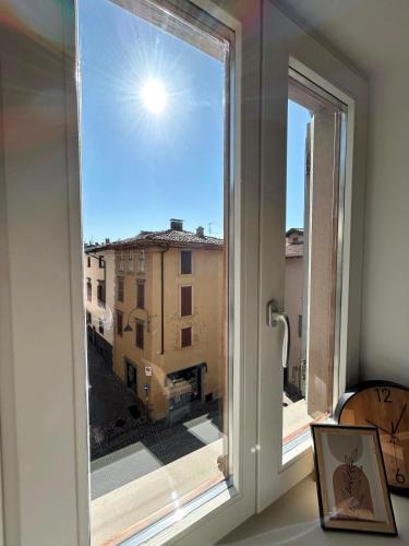 a window with a view of a building at Trilo Orologio in Clusone