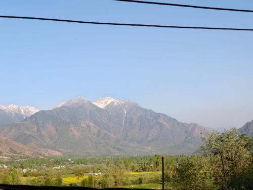 a view of a mountain range with snow at Raheemia Home Stay in Srinagar