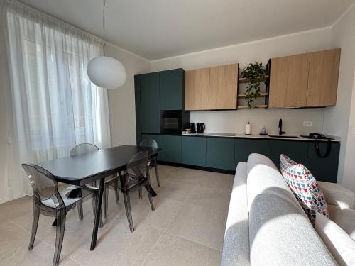 a kitchen and dining room with a black table and chairs at Il Torretto in La Spezia