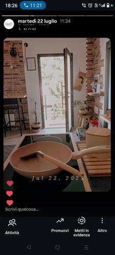 a page of a website with a wooden table in a room at Civico36 in Ilbono