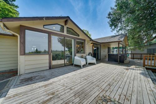 a house with a large deck with white chairs at half Mi to Yarrow Bay Family Home in Kirkland in Kirkland