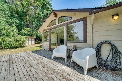a deck with two white chairs and a table at half Mi to Yarrow Bay Family Home in Kirkland in Kirkland