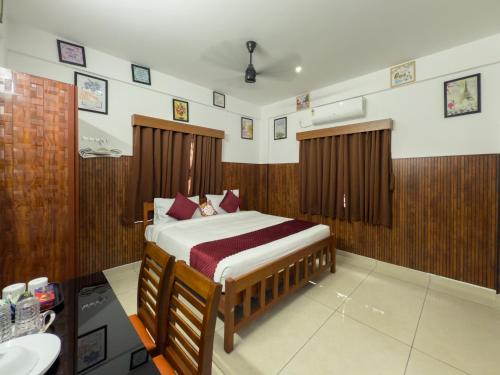 a bedroom with a bed and a sink in it at TREE 9 COCHIN AiRPORT HOTEL in Nedumbassery