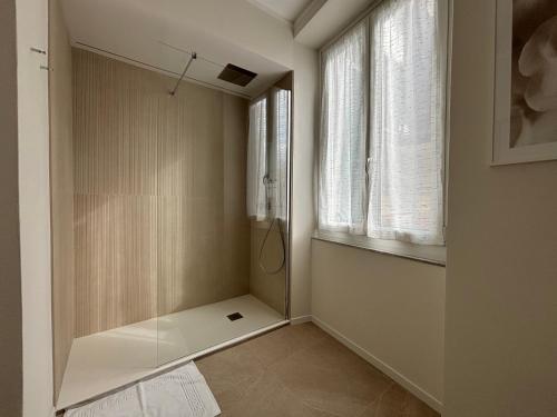 a walk in shower in a room with a window at Il Torretto in La Spezia