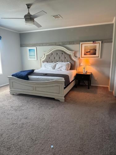 a bedroom with a large bed with a white headboard at SLCa in Austin