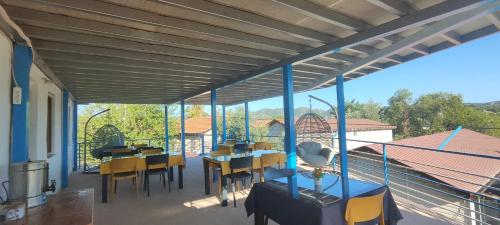 a patio with tables and chairs on a balcony at Neşe &Alp Apart Pansiyon in Demre