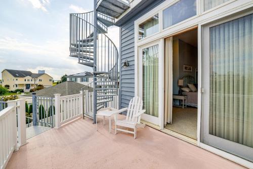 a balcony with a staircase and a chair on a house at 1 Block to Inlet Beach Brigantine Family Home in Brigantine