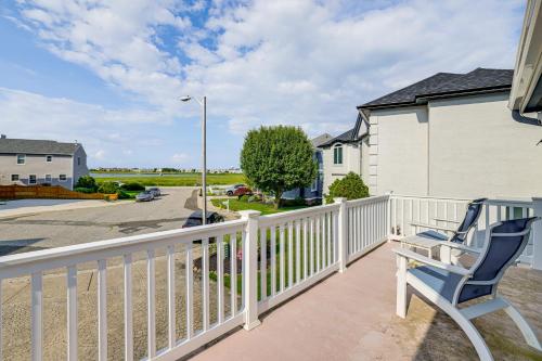 a balcony with a white fence and two chairs at 1 Block to Inlet Beach Brigantine Family Home in Brigantine