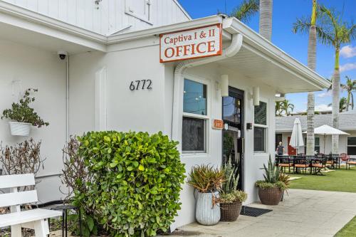 a white building with a sign that reads central is it office at Captiva Beach Resort (open private beach access) in Sarasota