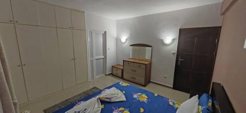 a bedroom with a bed and a dresser and a mirror at MP's Residence 202 in Pointe-Noire