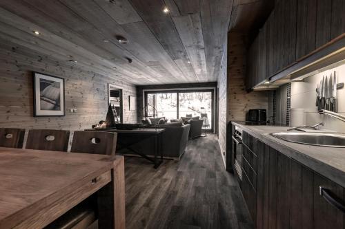 a kitchen and dining room with a table and chairs at Skigaarden in Hemsedal