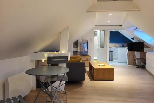 a living room with a couch and a table at Le Petit Langlet - Cathedral - hyper-center in Reims