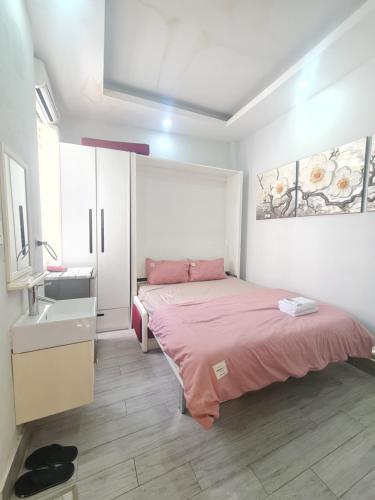 a small bedroom with a bed and a sink at The Hidden Hogwarts - Nearly Bui Vien Walking street in Ho Chi Minh City