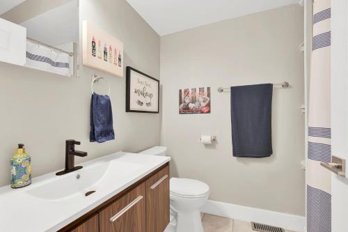 a bathroom with a white sink and a toilet at Nymph's Haven in Lake Geneva