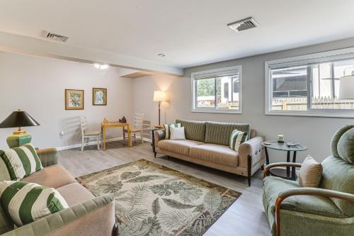 a living room with two couches and a table at Dock and Backyard Bar Spacious Barnegat Bay Retreat in Waretown