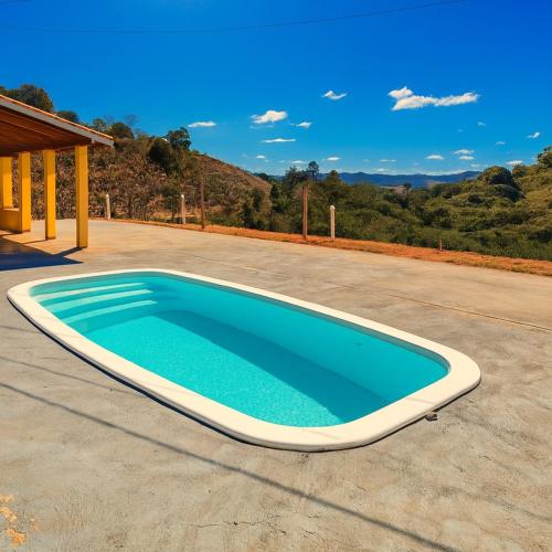 a large swimming pool on a patio at Pousada Recanto Dilello in Socorro