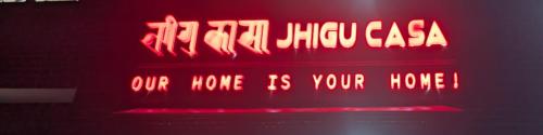 a neon sign that says our home is your house at JhiguCasa - Home away from home in Kirtipur