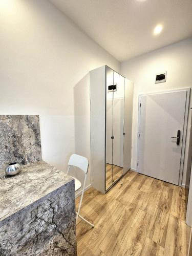 a room with a counter and a glass door at Apartmány v srdci Ružinova in Trnávka