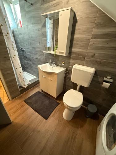 a bathroom with a toilet and a sink at Međimurski San in Lopatinec