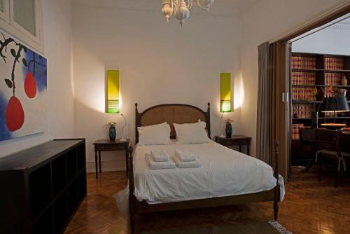 una camera da letto con un letto con due asciugamani sopra di Traditional apartment with garden a Lisbona