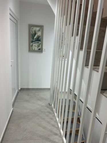a staircase in a white room with a picture on the wall at Studio Amanet in Umag