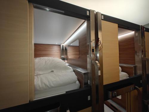 an open door to a bed in a room at I Street Capsule Hostel in Washington