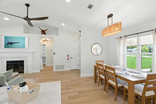a dining room and living room with a table and chairs at Sunny 3BR with Hot Tub & Game Room Home in Gulf Breeze