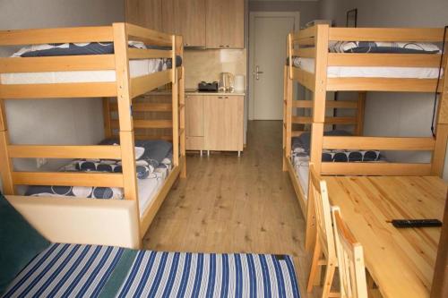 a room with four bunk beds and a kitchen at New Gudauri Loft #1,Room 411, 412 in Gudauri