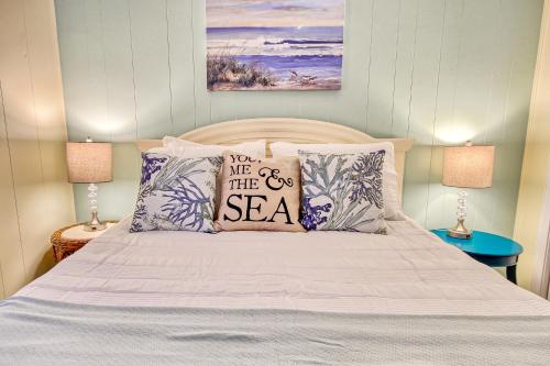 a bedroom with a bed with pillows saying you are the sea at Captain's Villa 6-D Our White Pearl in Holden Beach