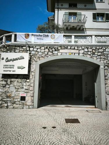 a building with a garage with a sign on it at Hotel Al Campanile - Luxury Suites & Apartments in Baveno