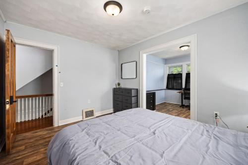 a bedroom with a large bed and a staircase at Private Room with Full Bed Cozy and Quiet in Peoria