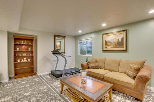 a living room with a couch and a table at Farr West Apartment on Farm Less Than 25 Mi to Ski Resorts in Farr West