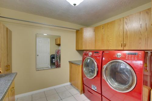a red washer and dryer in a kitchen at Farr West Apartment on Farm Less Than 25 Mi to Ski Resorts in Farr West
