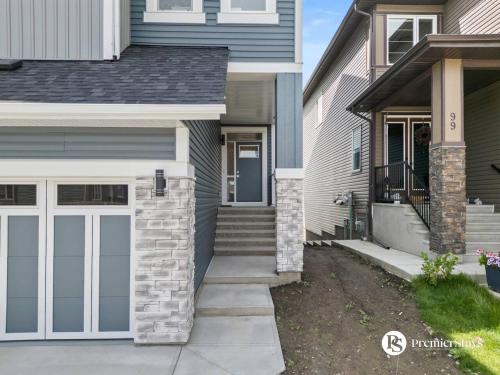 a front door of a house with a garage at Luxurious Detached House with Private Garage, Lake View, Central AC & More in Airdrie