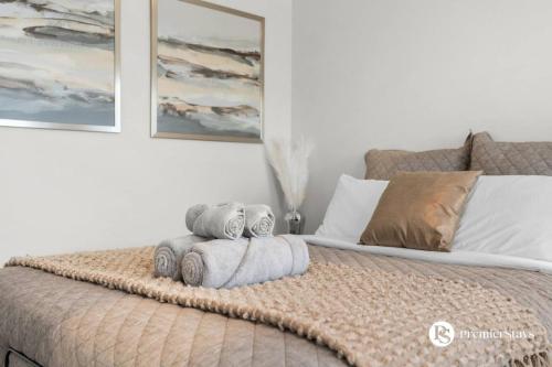 a bedroom with a bed with towels on it at Luxurious Detached House with Private Garage, Lake View, Central AC & More in Airdrie