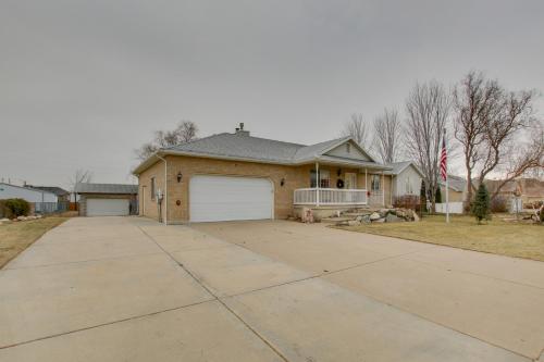 a house with a garage and an american flag at Farr West Apartment on Farm Less Than 25 Mi to Ski Resorts in Farr West